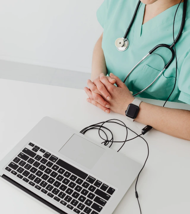 A doctor using a laptop